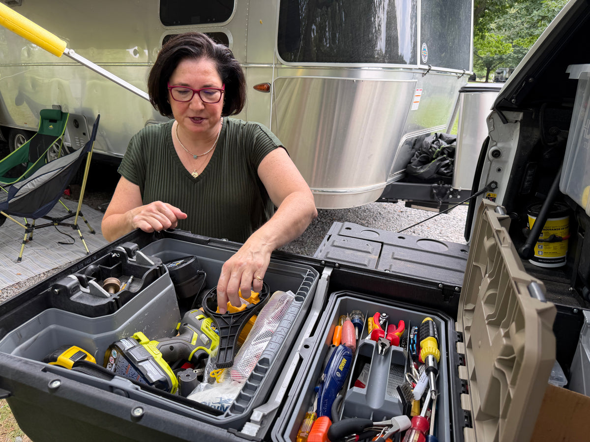 Jennifer Eggers organizing tools beside her Airstream